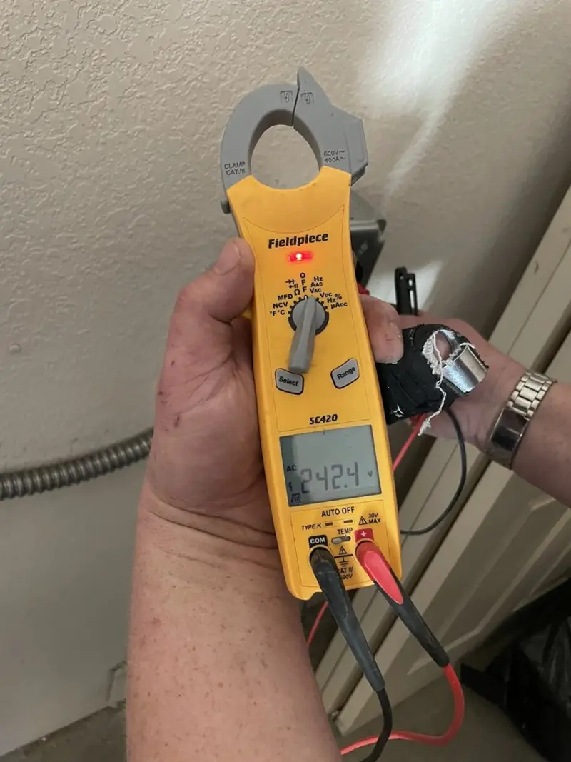 Voltage testing with clamp meter during Electrical Installation Services in Kiel
